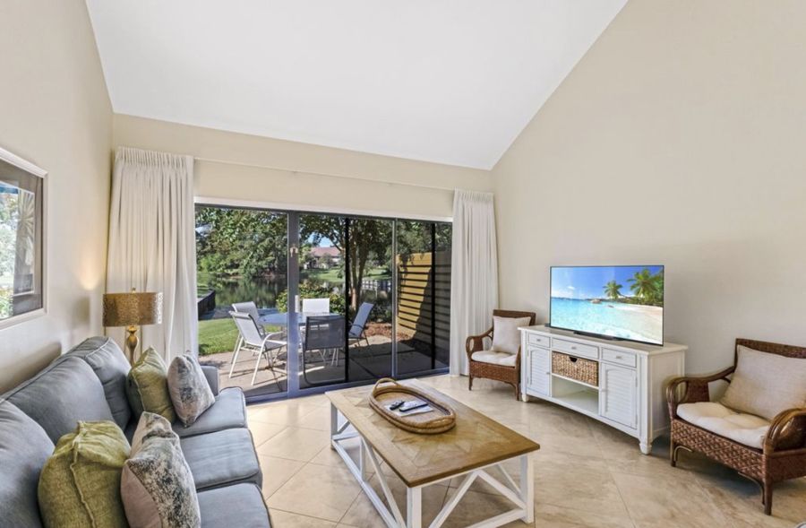 Living room with a vaulted ceiling and a view of the lake