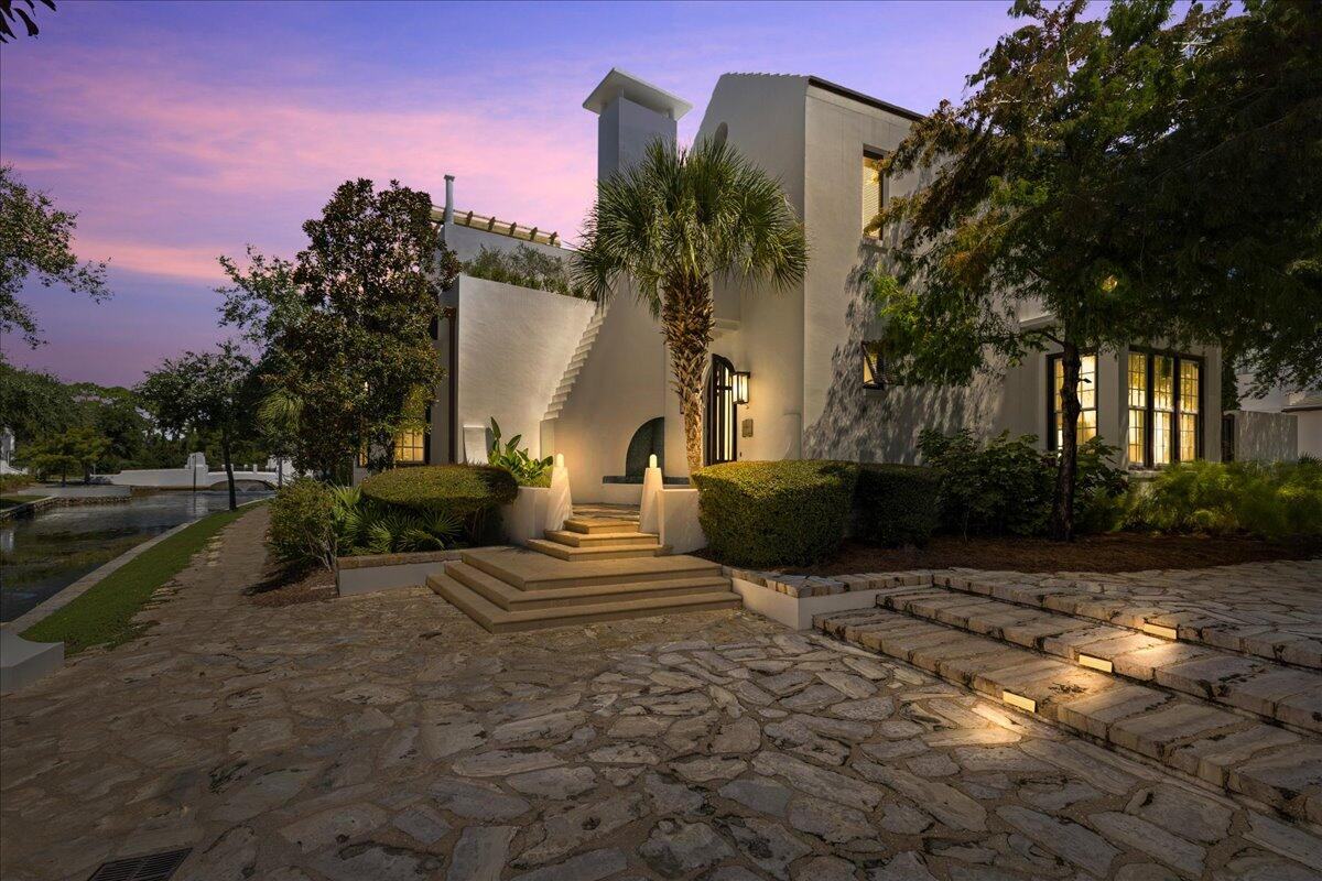 Front of the home at twilight, with the lit stone steps at 75 Hog Penny Alley